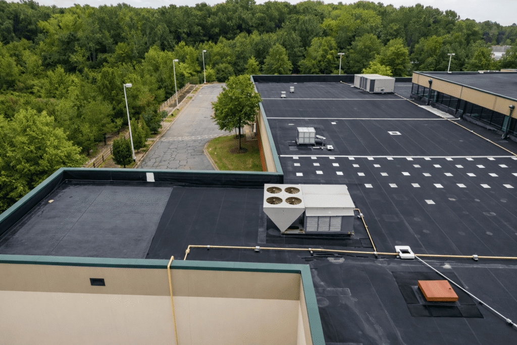 Newly installed commercial flat roof system on a large building to improve waterproofing and energy efficiency.