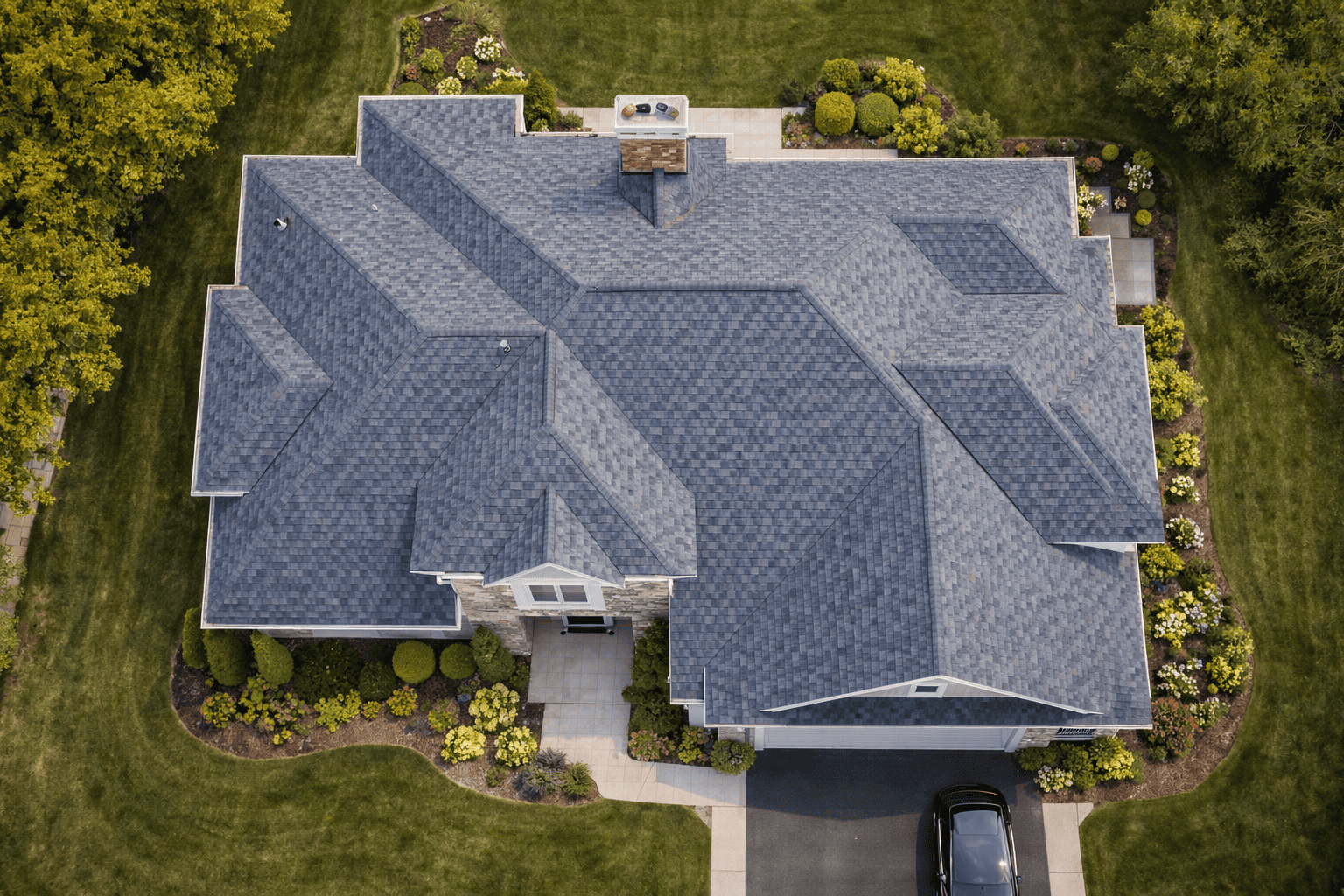 Top-down aerial view of large residential roof with skylights and multiple sections by Bluebeam Group in Orange County NJ